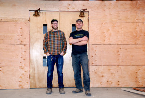 Ben Parsons, left, and Rik Hall stand outside the mill room they built at Baerlic Brewing in Portland.